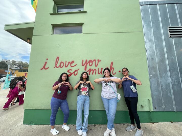 Bevo Buddy! students in front of the famous I Love You So Much mural