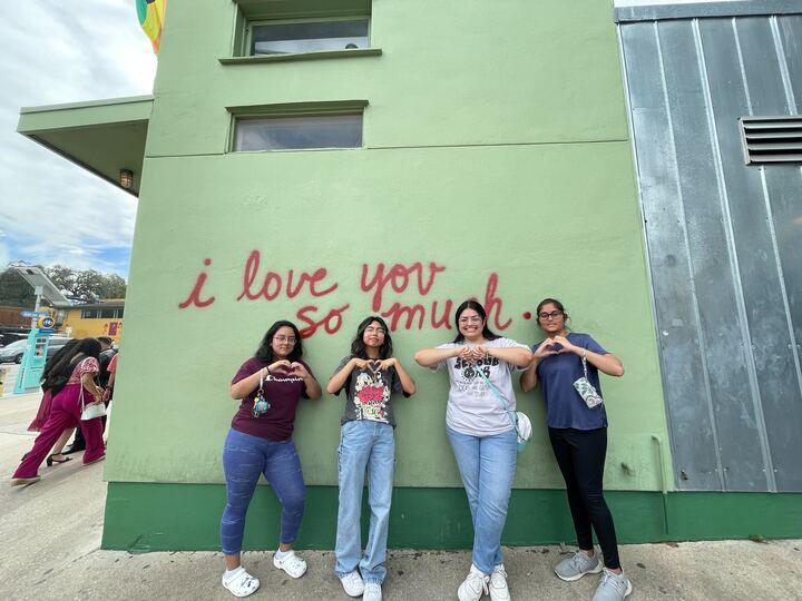 Bevo Buddy! students in front of the famous I Love You So Much mural