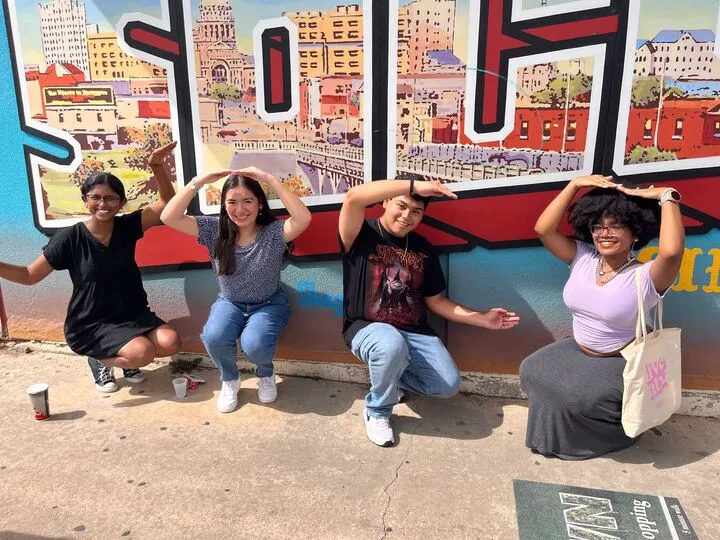 Bevo Buddy students in front of the South Congress mural