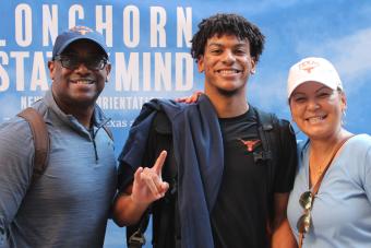 Incoming Longhorn poses with family at orientation