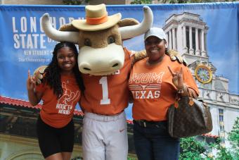 Mom and daughter pose with Hook Em at orientation