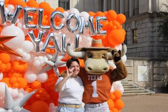 Student poses with Hook 'Em at Welcome Bash 2023.