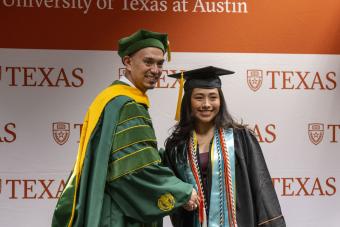 Dr. Robert Valdez shakes hands with a student at First-Gen Grad.