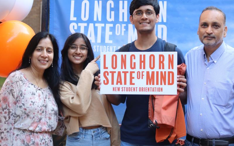 family posing with the Longhorn State of Mind cutout
